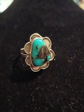 Vintage Navajo sterling silver ring featuring three turquoise stones arranged ve